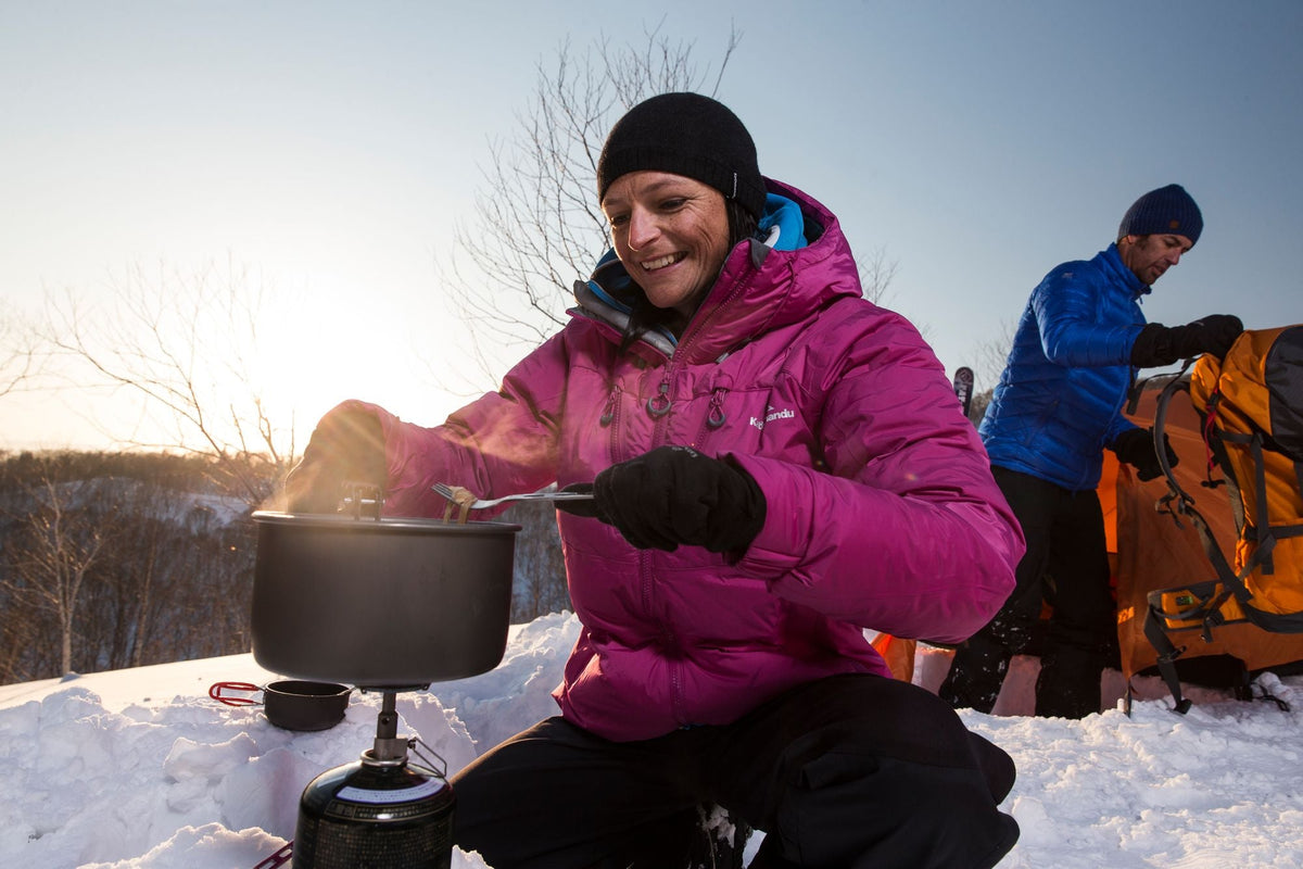 A person cooking at camp