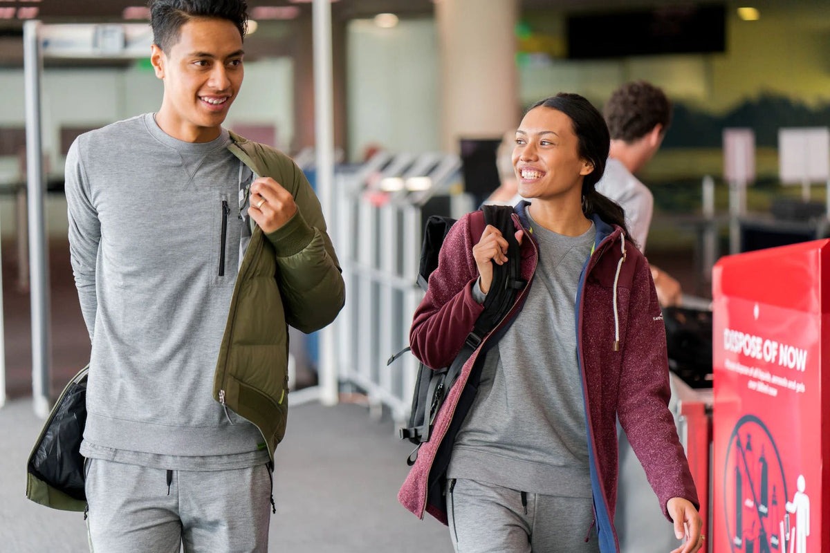 A couple is walking through airport security.